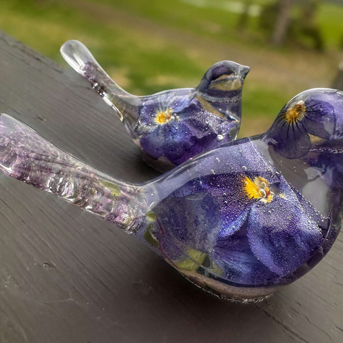 Memorial resin bird with ashes, pair of clear resin songbirds with purple forget-me-nots and shimmering bases