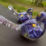 Memorial resin bird with ashes, pair of clear resin songbirds with purple forget-me-nots and shimmering bases