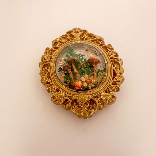 Close up of real foraged mushrooms standing in clear resin inside the mushroom fridge magnet
