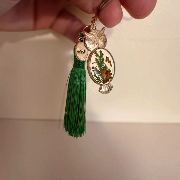 Mushroom owl keychain with green tassel, lobster clasp and keyring laid flat