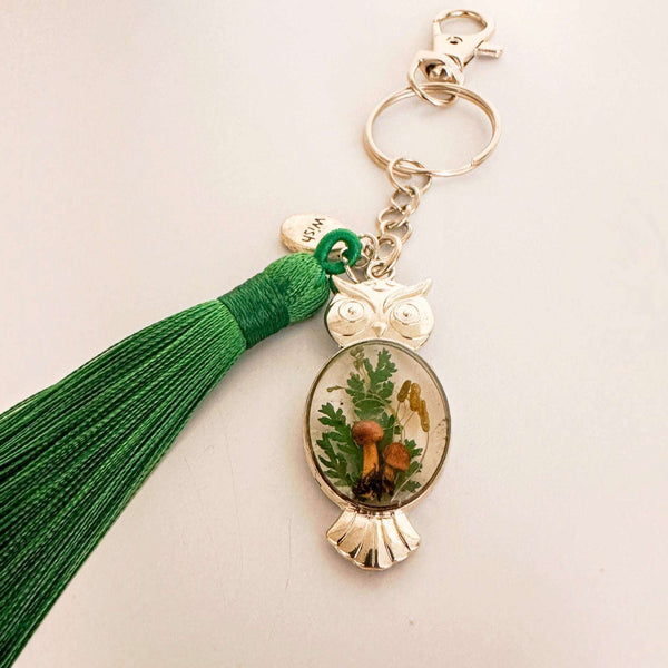 Silver owl keychain with real foraged mushrooms and green ferns set in clear resin