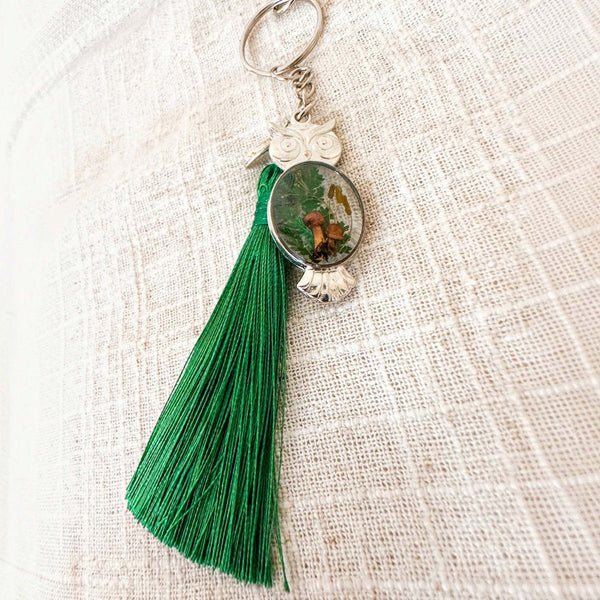 Silver mushroom owl keychain showing the resin belly with two small brown mushrooms