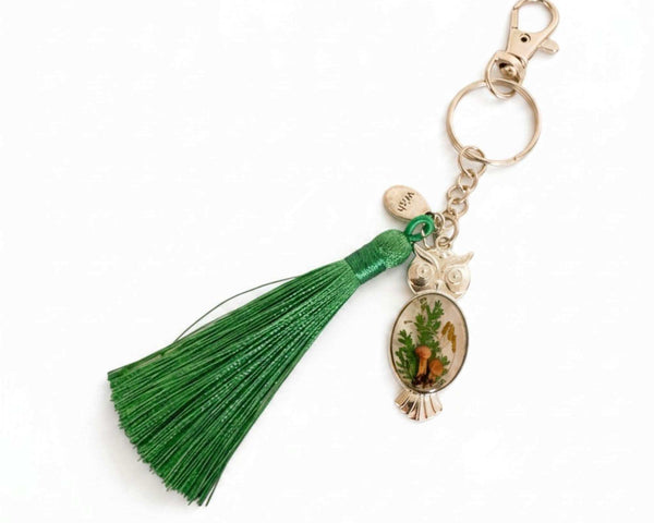Mushroom owl keychain in silver with real mushrooms and ferns set in resin and a green tassel