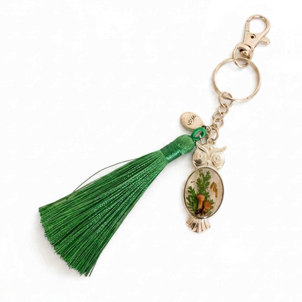 Mushroom owl keychain in silver with real mushrooms and ferns set in resin and a green tassel