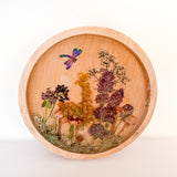 mushroom trinket dish in natural round wood with clear resin, raised mushrooms, pressed botanicals and a dragonfly