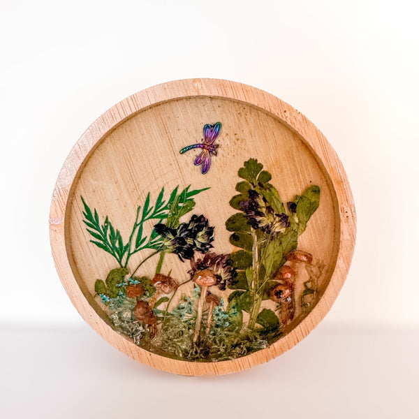 Mushroom trinket dish in natural round wood with clear resin, raised mushrooms, pressed ferns and a purple dragonfly charm