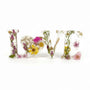 Wild Rose LOVE Word Art in clear resin, featuring pressed pink and white flowers, yellow daisies, greenery, and a heart-shaped O.
