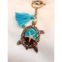 Ocean Keeper sea turtle keychain with antique bronze metal, turquoise and brown resin, sand, and a starfish charm