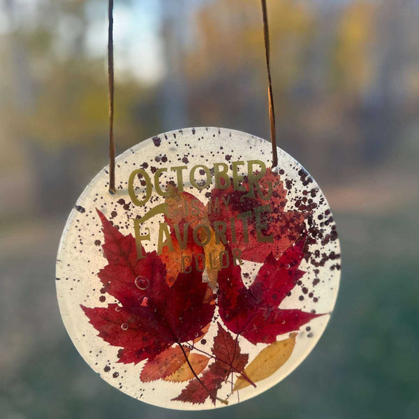 October Glow round maple leaf resin wall art with red and gold leaves, copper glitter and embedded lettering