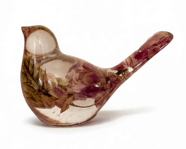 Pink lupine resin bird figurine in glossy clear resin, with preserved pink and olive botanicals and a long raised tail.