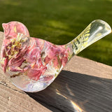 pink lupine resin bird decor with clear resin, layered pink flowers, a fern in its tail, and glitter along the base.