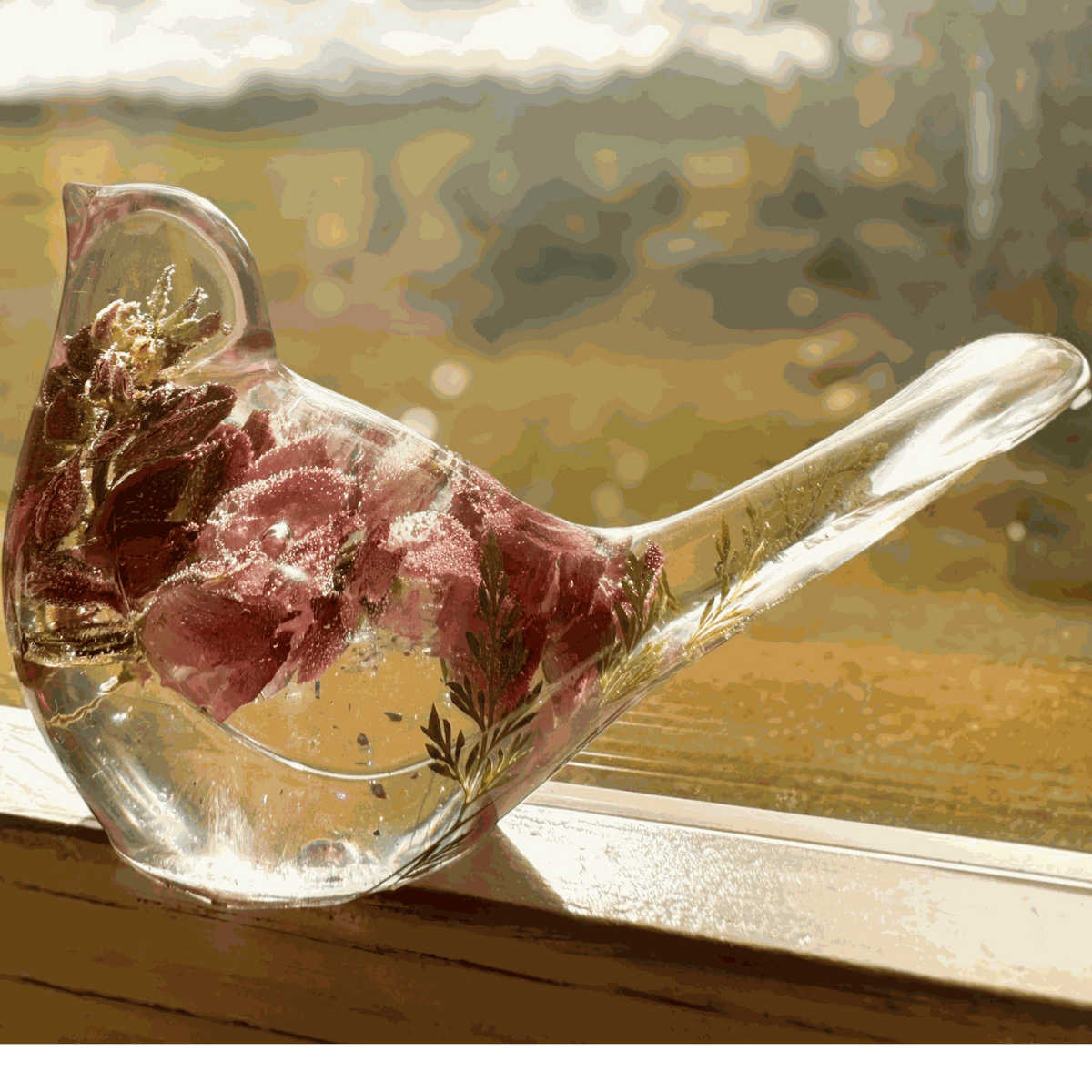 pink lupine resin bird decor with clear sculpted resin, pink dried blooms, green fern tail and glittered base