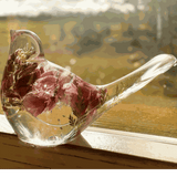 pink lupine resin bird decor with clear sculpted resin, pink dried blooms, green fern tail and glittered base