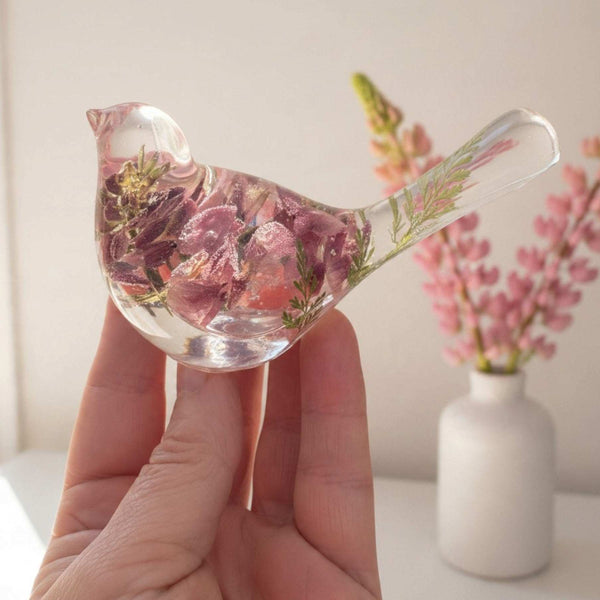 pink lupine resin bird decor in clear resin, with dimensional rose and dusty pink blooms and a green fern in its tail