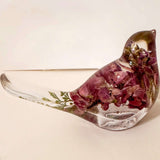 pink lupine resin bird decor with deep rose dried flowers, green fern in a clear resin tail, and a glossy finish