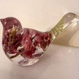 pink lupine resin bird decor with translucent clear body, deep rose dried flowers, and a green fern in its raised tail