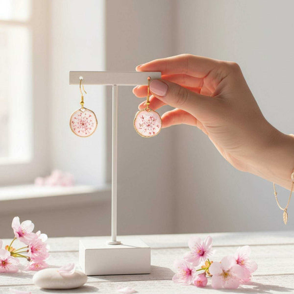 Close up of dark pink Queen Anne's Lace and a tiny floating butterfly inside pink floral butterfly earrings.