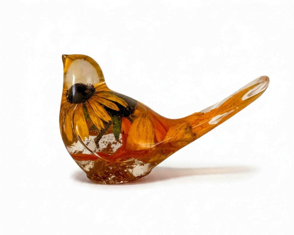Golden Meadow resin bird featuring a preserved yellow flower with a dark centre and amber-gold accents in clear resin.