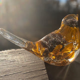 Black eyed susan resin bird with amber-clear resin, golden petals and dark brown flower centres, in a rounded shape with a clear tail.