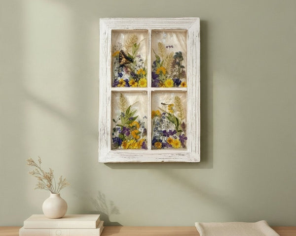 Pressed flower window art held up to the winter light, showing the translucent resin panes