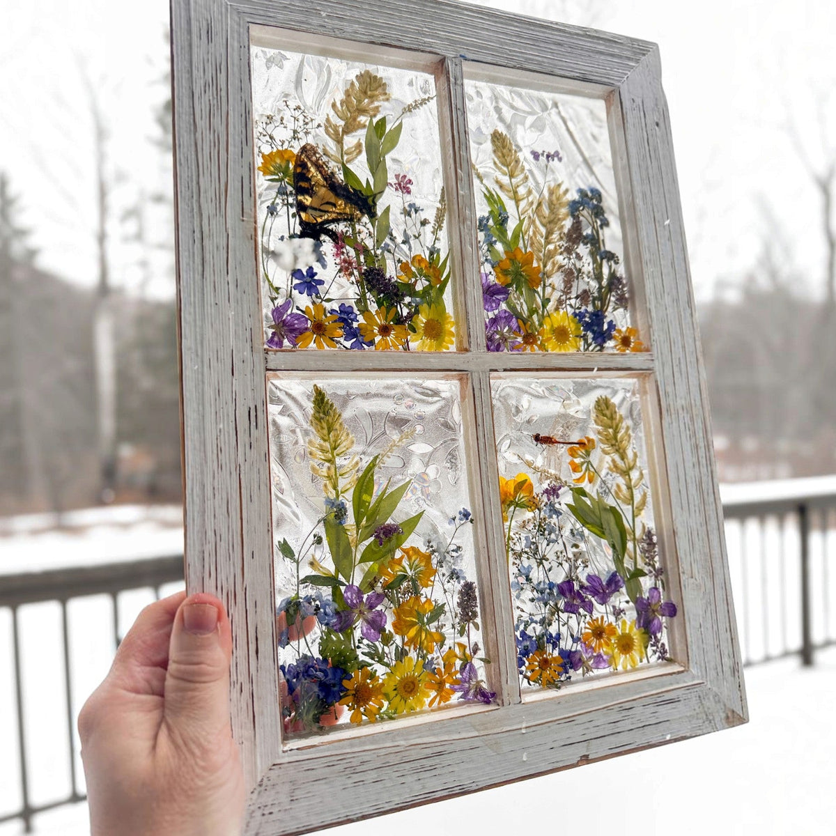 Detail of the swallowtail butterfly with open wings inside the pressed flower window art