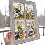 Detail of the swallowtail butterfly with open wings inside the pressed flower window art