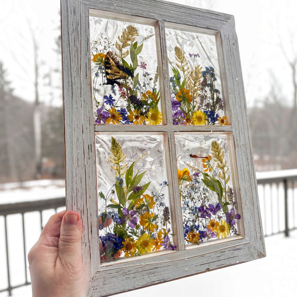 Detail of the swallowtail butterfly with open wings inside the pressed flower window art