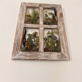 Pressed flower window art in a whitewashed wood frame, with four clear resin panes of colorful dried flowers and greenery