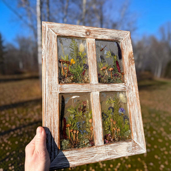 Pressed flower window art in a whitewashed wood frame, with four clear resin panes filled with colorful flowers and greenery