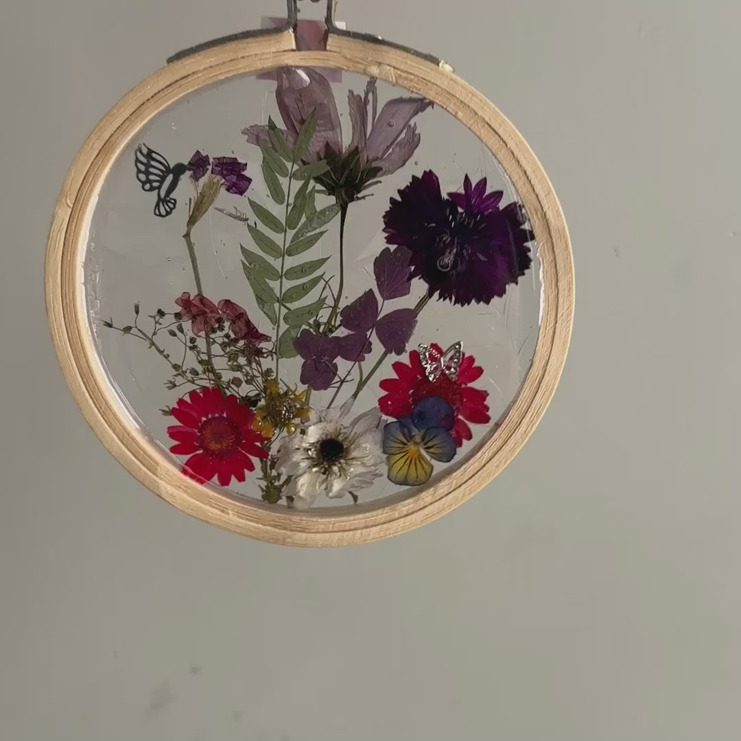 Load video: dried flowers in resin suncatcher