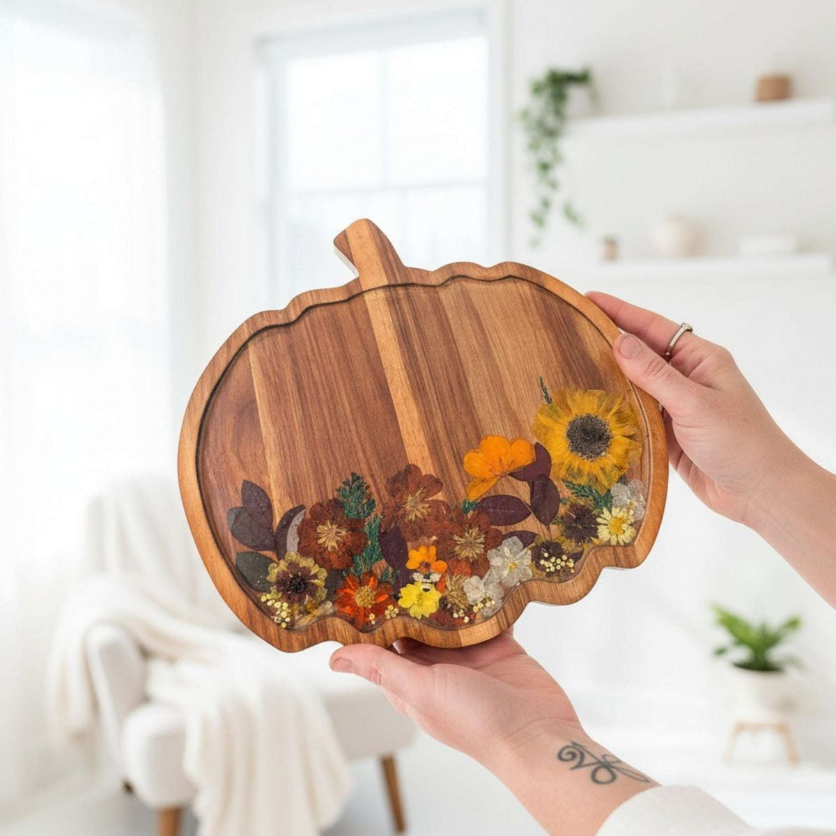 Handmade wooden pumpkin tray with real pressed sunflower, dried botanicals, bee charm, and gold glitter for fall decor