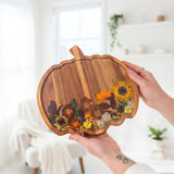 Handmade wooden pumpkin tray with real pressed sunflower, dried botanicals, bee charm, and gold glitter for fall decor