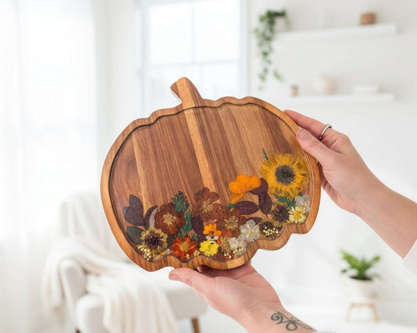 Handmade wooden pumpkin tray with real pressed sunflower, dried botanicals, bee charm, and gold glitter for fall decor