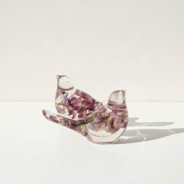 Two purple lupine resin bird figurines together, light purple and dark purple