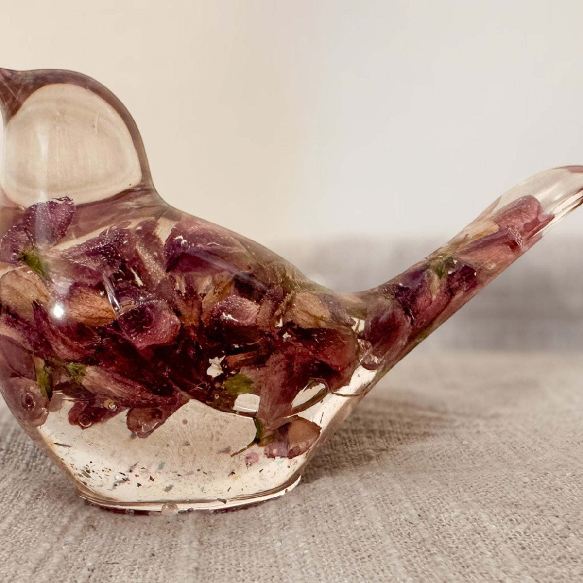 Purple lupine resin bird with sunlight passing through the petals