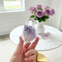 Handcrafted purple rose resin bird decor with preserved lavender rose inside