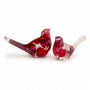 Close-up of glossy red berries suspended in clear hand-poured resin bird with red glitter shimmer