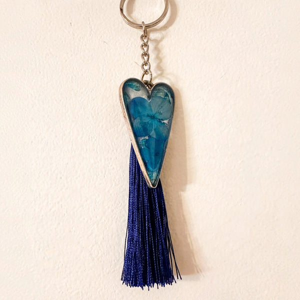 Sapphire Heart keychain with blue flowers in a teal resin heart, silver chain and long navy tassel