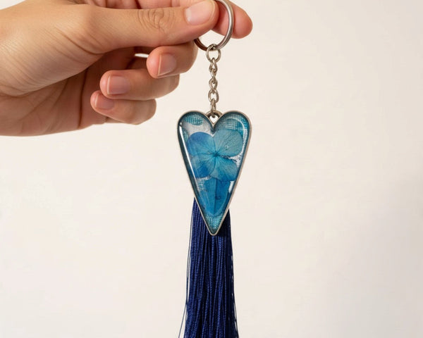 Sapphire Heart keychain with blue dried flowers in a silver-edged resin heart and a long navy tassel