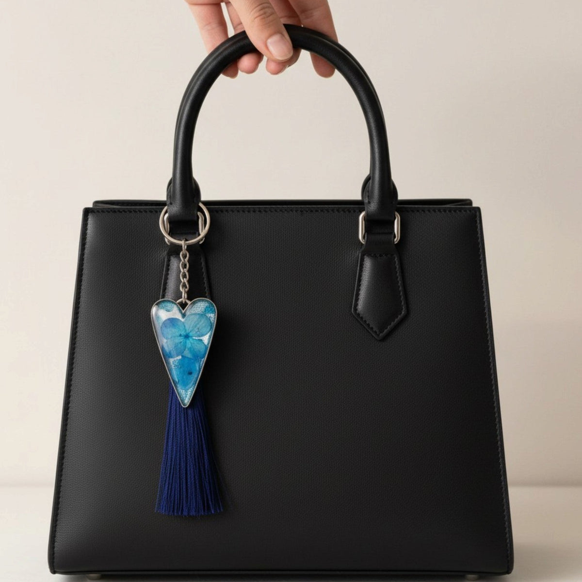 Sapphire Heart keychain with a silver-edged heart pendant, blue flower pattern in resin, and long navy tassel