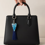 Sapphire Heart keychain with a silver-edged heart pendant, blue flower pattern in resin, and long navy tassel