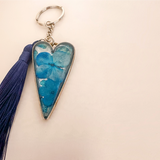 Sapphire Heart keychain with vivid blue dried flowers in a silver heart frame and a long navy tassel