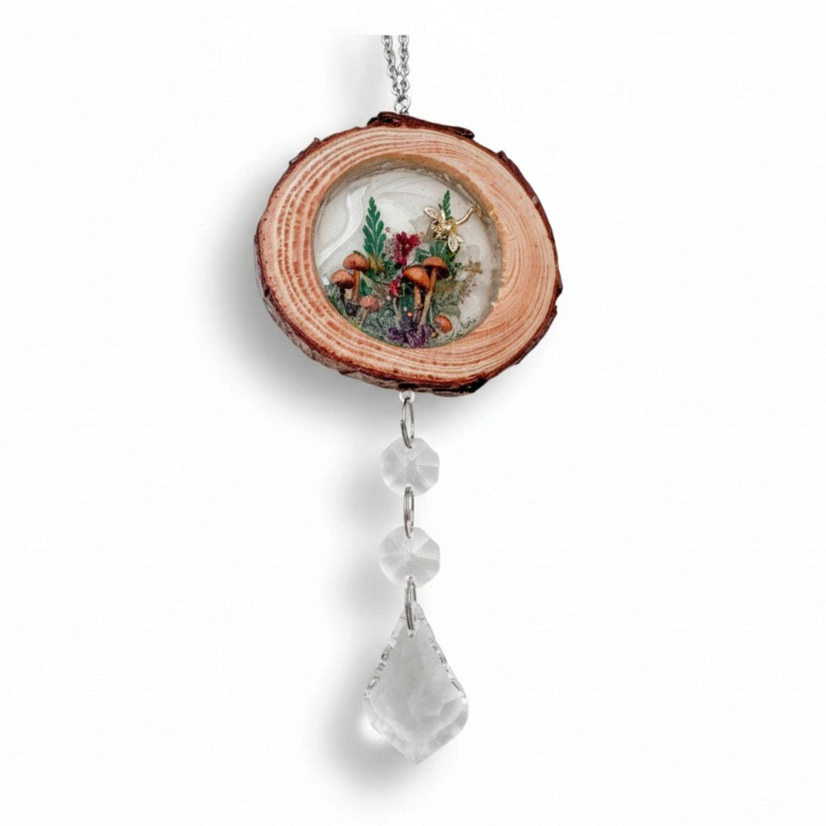 Suncatcher with a natural wood slice frame, miniature mushroom and fern scene, and clear faceted crystal drops