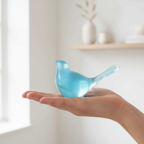 teal glow resin bird decor, glossy translucent blue-green bird figurine with a rounded body and raised tail