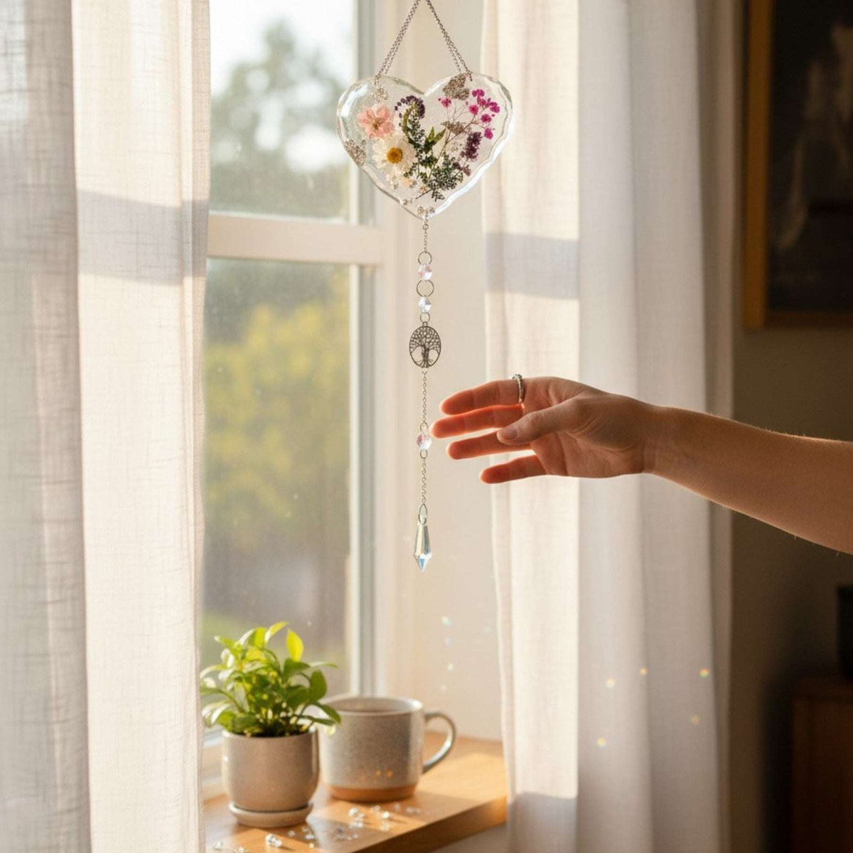 Garden Whisper Suncatcher pressed flower resin heart hanging in a sunny window casting rainbow light