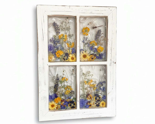 Pressed Flower Window Frame with a distressed white wood frame, four clear panes, and yellow and purple dried flowers.