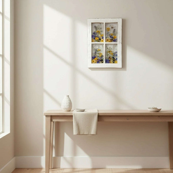 Pressed Flower Window Frame wall art in white distressed wood, with four clear panes of colorful pressed flowers and a dragonfly.