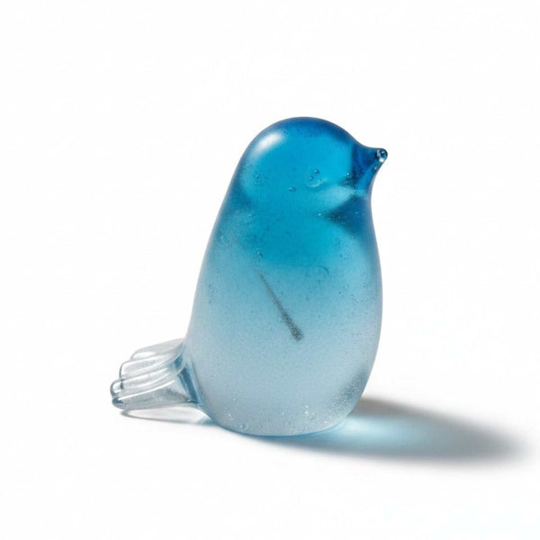 Handmade glow in the dark resin bird decor with preserved dandelion puff inside, glowing blue in the dark.