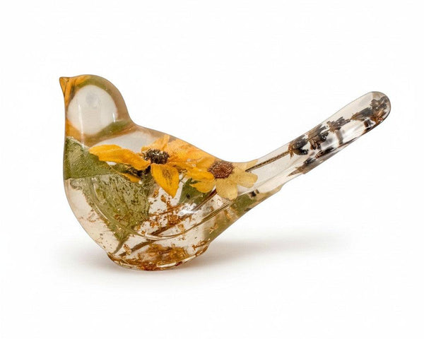 Yellow sunflower resin bird decor with a clear glossy body, dried yellow blooms, green foliage and brown botanical details