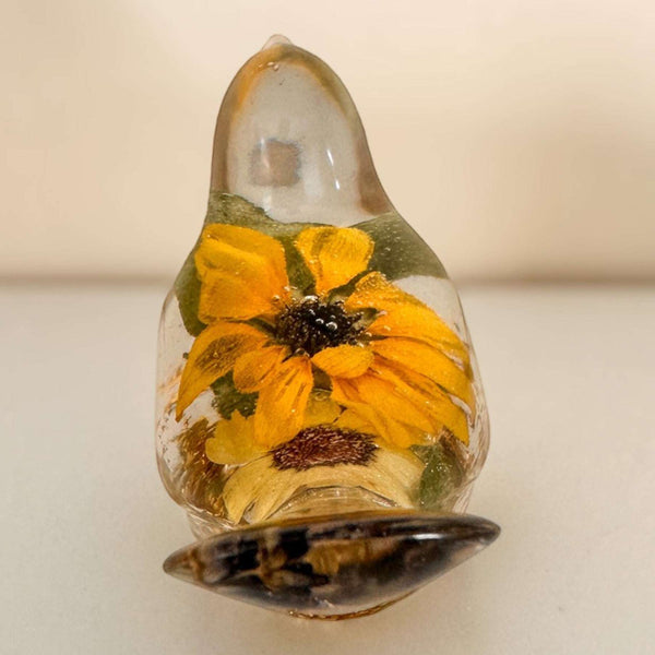 yellow sunflower resin bird decor with clear teardrop-shaped body, vivid orange-yellow petals and dark seed centre